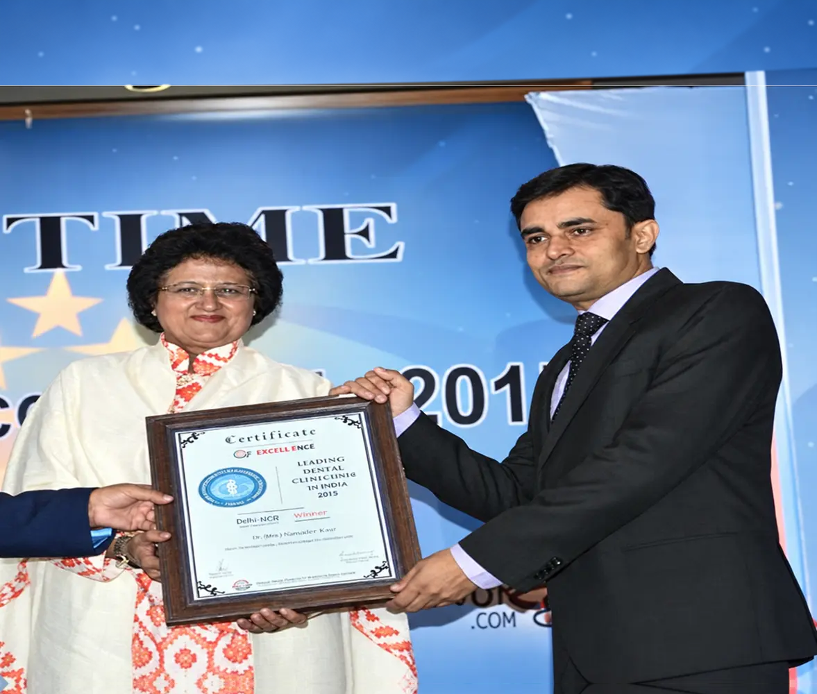 Dental Samagra receiving a certificate of excellence in dentistry